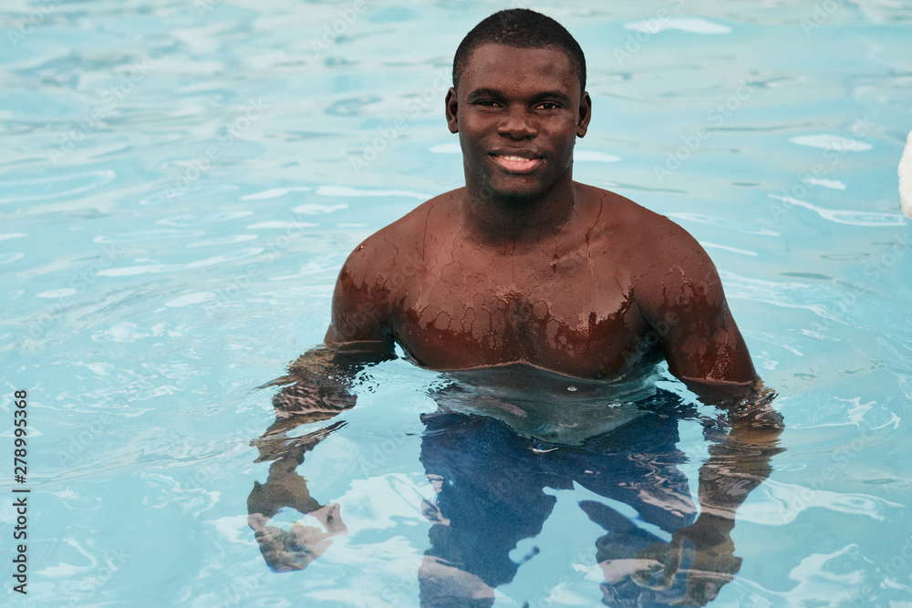 young man in swimming pool young man in swimming pool