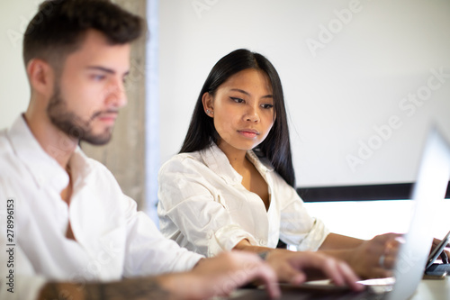 Young couple working in group