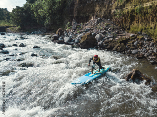 Man paddle boarding the river