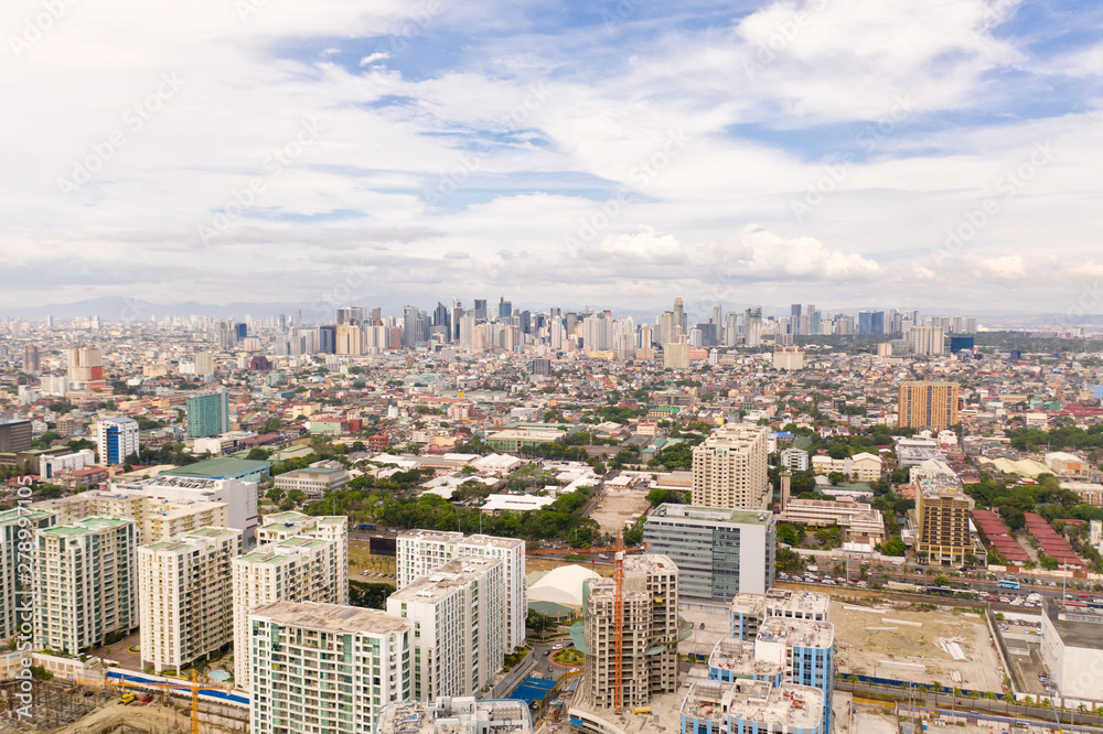 The city of Manila, the capital of the Philippines. Modern metropolis in the morning, top view. New buildings in the city. Panorama of Manila. Skyscrapers and business centers in a big city.