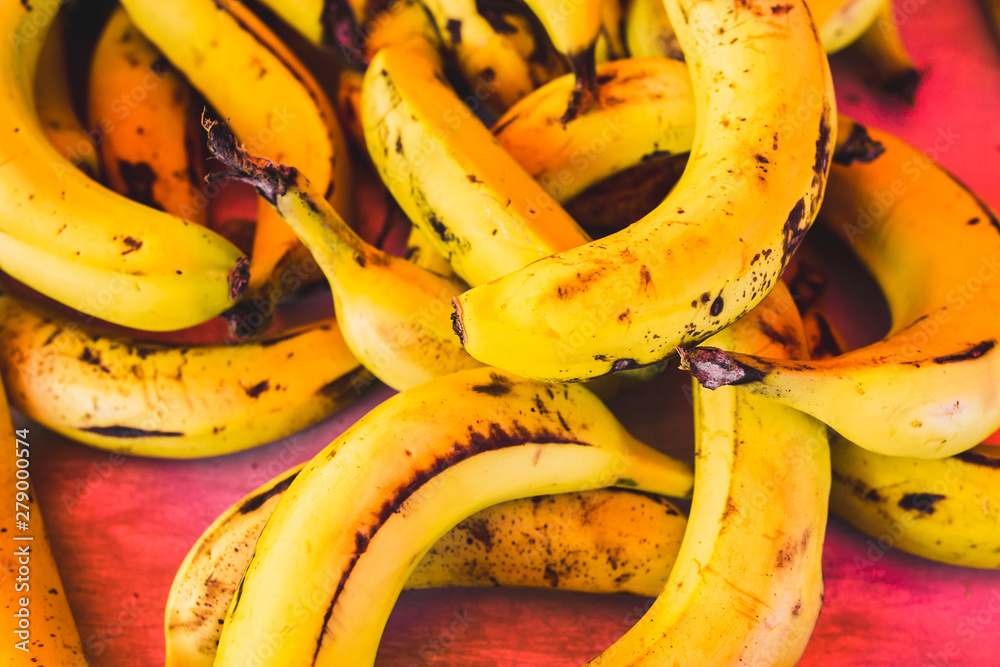 Close up of many juicy ripe bananas on the counter - traditional Mediterranean market - selected top-quality organic products