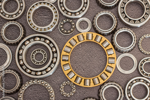 Various bearings on a black concrete background.