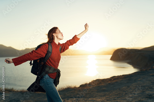 happy woman with arms outstretched on the beach