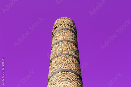 Purple background bottom shoot of old masonry brick factory chimney photo