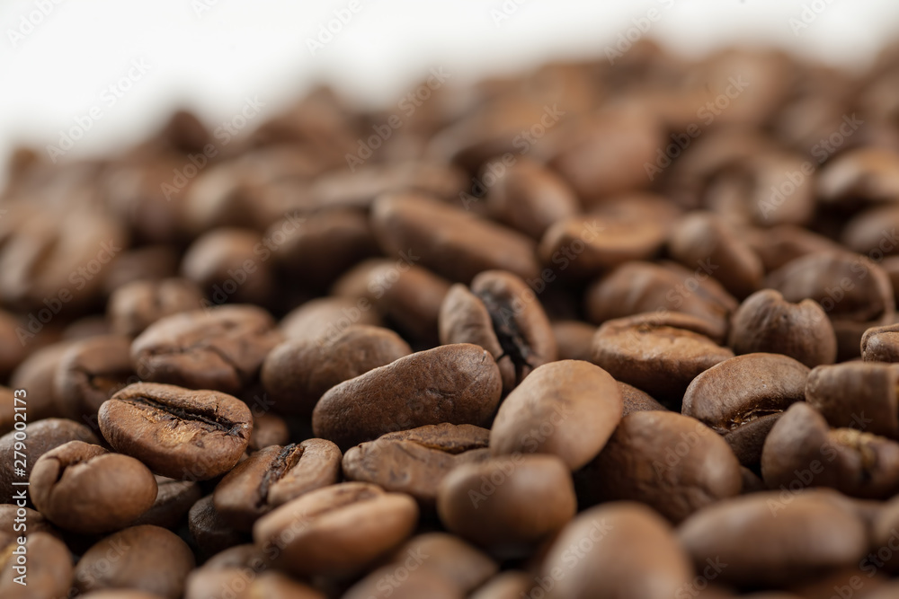 Roasted coffee beans on white background, macro Roasted coffee beans on white background, macro