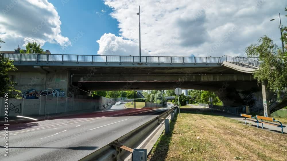 Busy Street Traffic Scene with Bridge and Cloudy Blue Sky Busy Street Traffic Scene with Bridge and Cloudy Blue Sky