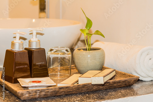 Hotel and spa amenities on a wooden tray