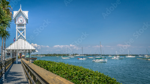Small boats docked next to the historic Bradenton Beach pier on Anna Maria island in Florida.