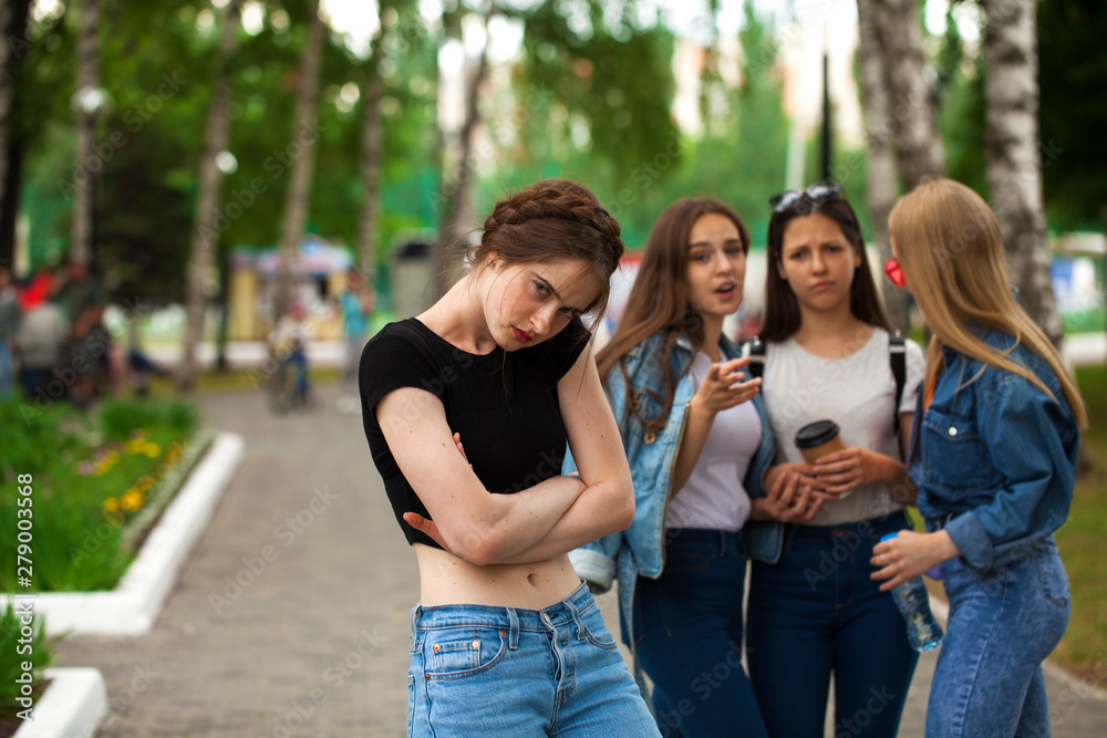 Four schoolgirls in summer park