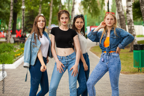 Four schoolgirls in summer park