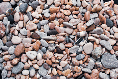 Multicolored colorful sea pebbles, natural background, texture. Close-up texture of colorful sea pebbles. Small Rock. Sea background