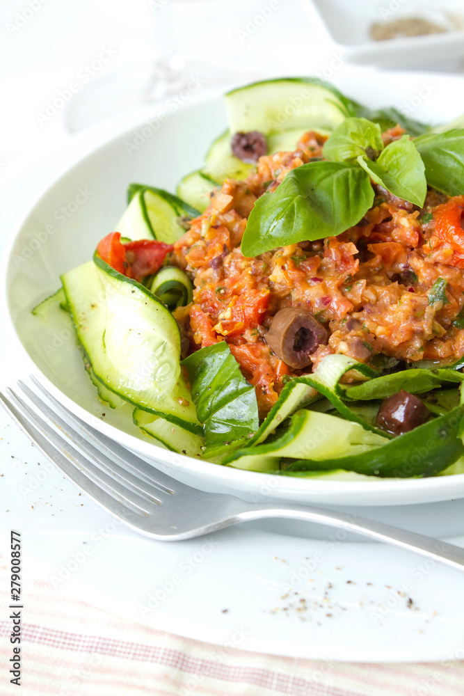 Raw Zucchini Pasta with a tomato and olive sauce Raw Zucchini Pasta with a tomato and olive sauce