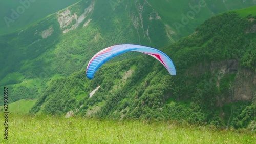 parashutist, paraglider, flying over the mountains, beautiful scenery of Georgia. photo