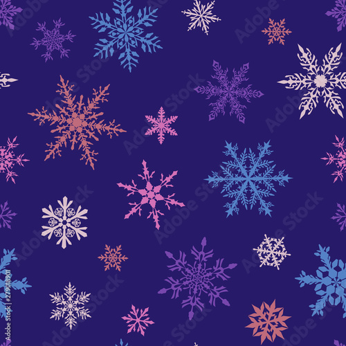 Christmas seamless pattern of complex big and small multicolored snowflakes on blue background