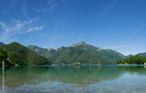 Mountain reflections in the water of Lago Di Ledro. Trento, Italy