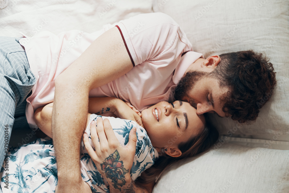 Couple in love is embracing on the bed Couple in love is embracing on the bed