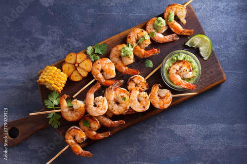 Cilantro lime grilled shrimps. Shrimps on skewers with garlic butter sauce. View from above, top studio shot