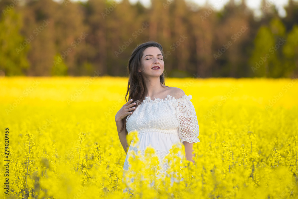 Pregnant girl on a yellow background. looks at his stomach, imagines his unborn child. Maternity concept Pregnant girl on a yellow background. looks at his stomach, imagines his unborn child. Maternity concept
