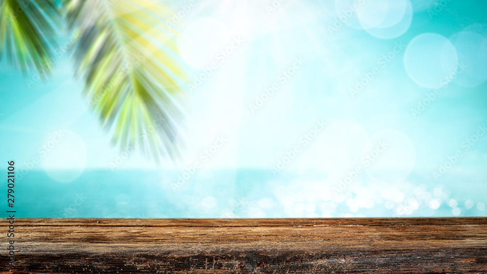 Table background with the beautiful ocean and beach view. Palm leaves frame. Blank space for a product. Table background with the beautiful ocean and beach view. Palm leaves frame. Blank space for a product.