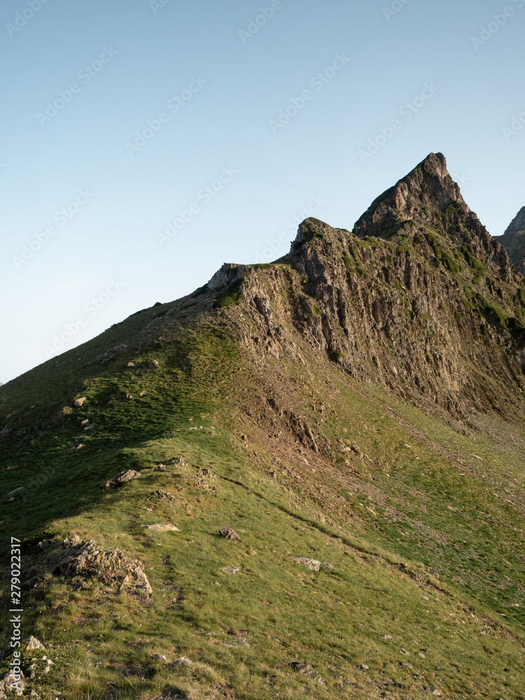 Mountain ridge with green hills at the bottom