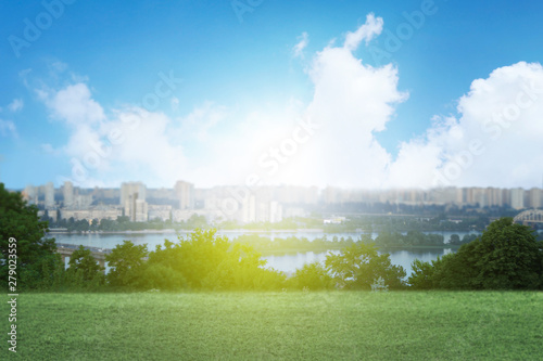 Green grass and beautiful view of cityscape on sunny day