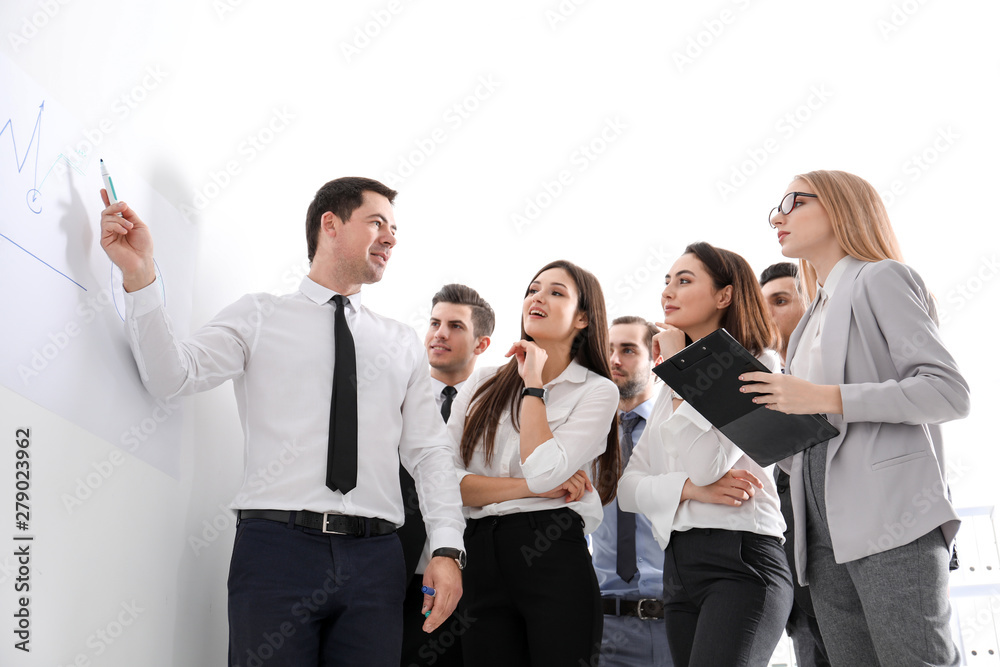 Group of people with business trainer at management seminar Group of people with business trainer at management seminar