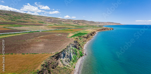 Aerial view of Lake Van the largest lake in Turkey, lies in the far east of that country in the provinces of Van and Bitlis. Fields and cliffs overlooking the crystal clear waters. Roads