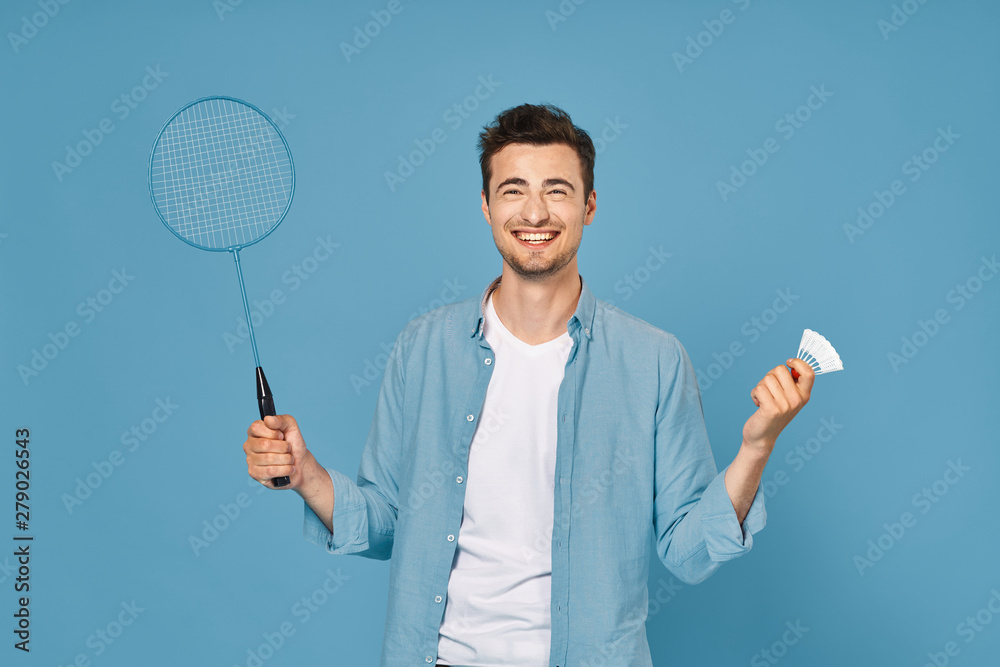 portrait of young man with tennis racket and ball