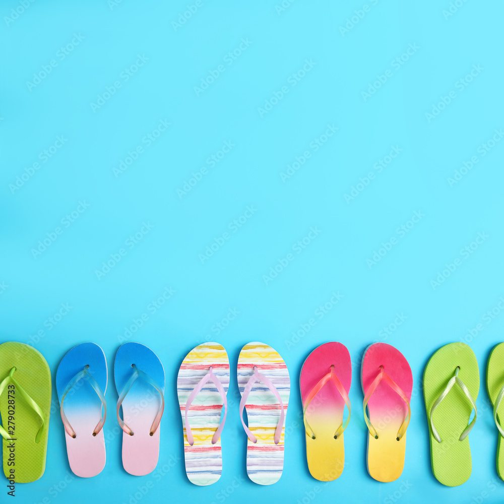 Different flip flops and space for text on blue background, flat lay. Summer beach accessories Different flip flops and space for text on blue background, flat lay. Summer beach accessories