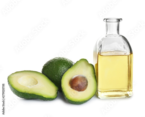 Bottle of natural oil and avocados isolated on white