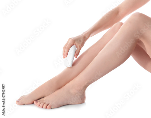 Young woman doing leg epilation procedure on white background, closeup