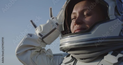 Astronaut opening helmet on Mars