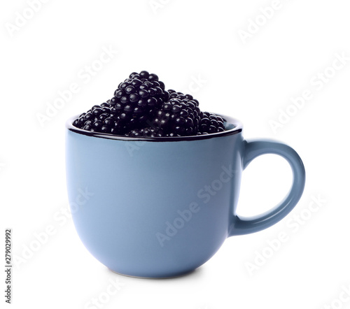 Blue cup of tasty blackberries on white background