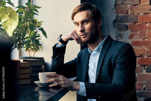 businessman sitting at table and talking on phone