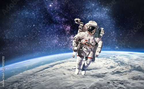 Fototapeta Naklejka Na Ścianę i Meble -  Astronaut in the outer space over the planet Earth. Abstract wallpaper. Spaceman. Elements of this image furnished by NASA