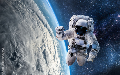 Fototapeta Naklejka Na Ścianę i Meble -  Astronaut in the outer space over the planet Earth. Abstract wallpaper. Spaceman. Elements of this image furnished by NASA