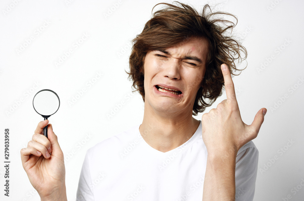young man with magnifying glass young man with magnifying glass