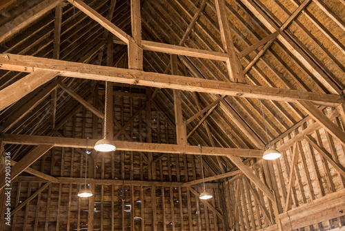 Inside view of old wooden roof wood structure with wooden beams in old barn