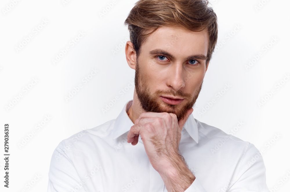 portrait of young man with his finger on lips portrait of young man with his finger on lips