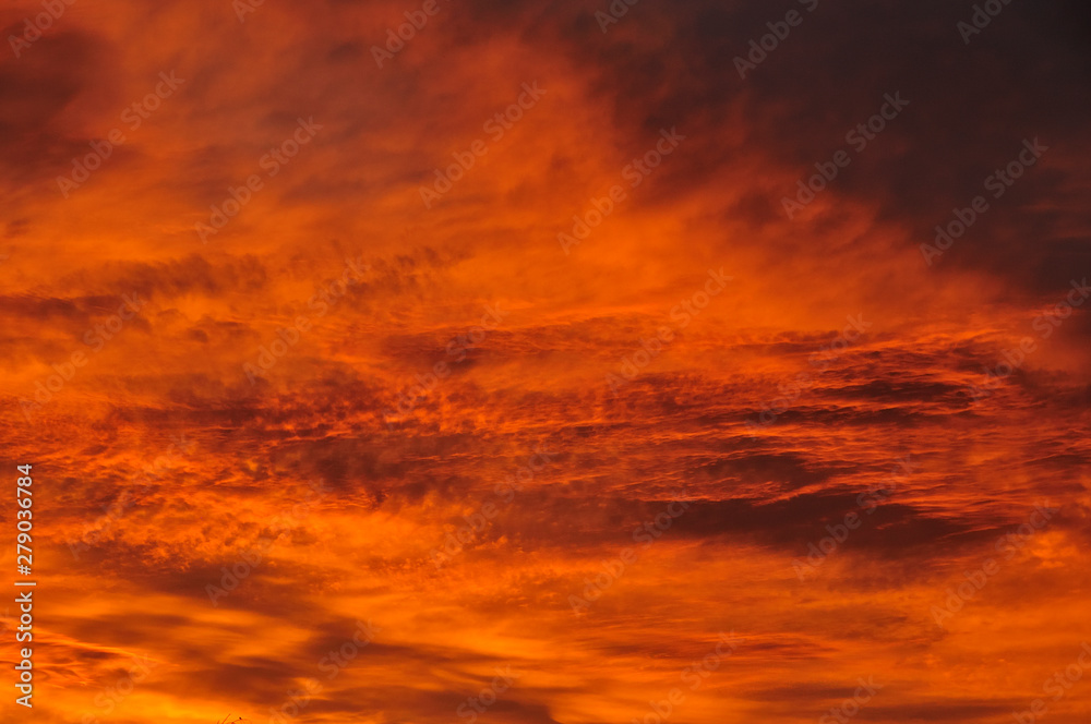 Texture, background, pattern. The sky is at sunset, dawn. Colored clouds, red, orange, pastel colors. Romantic pastel sky at dusk. sky with dynamic dramatic expressive clouds