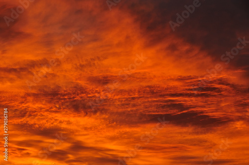 Texture, background, pattern. The sky is at sunset, dawn. Colored clouds, red, orange, pastel colors. Romantic pastel sky at dusk. sky with dynamic dramatic expressive clouds