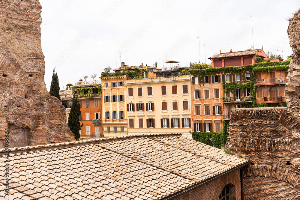 old colorful houses under grey sky in rome, italy