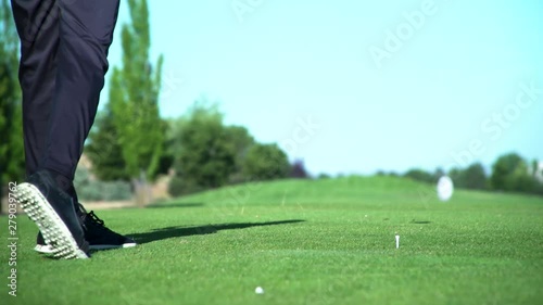 Golfer driving from the tee box