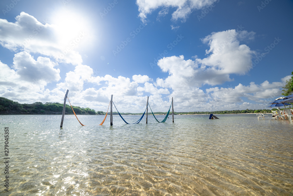 Fototapeta premium Tranquil water resting nets and bright sun. Natal, Rio Grande do Norte, Brazil.