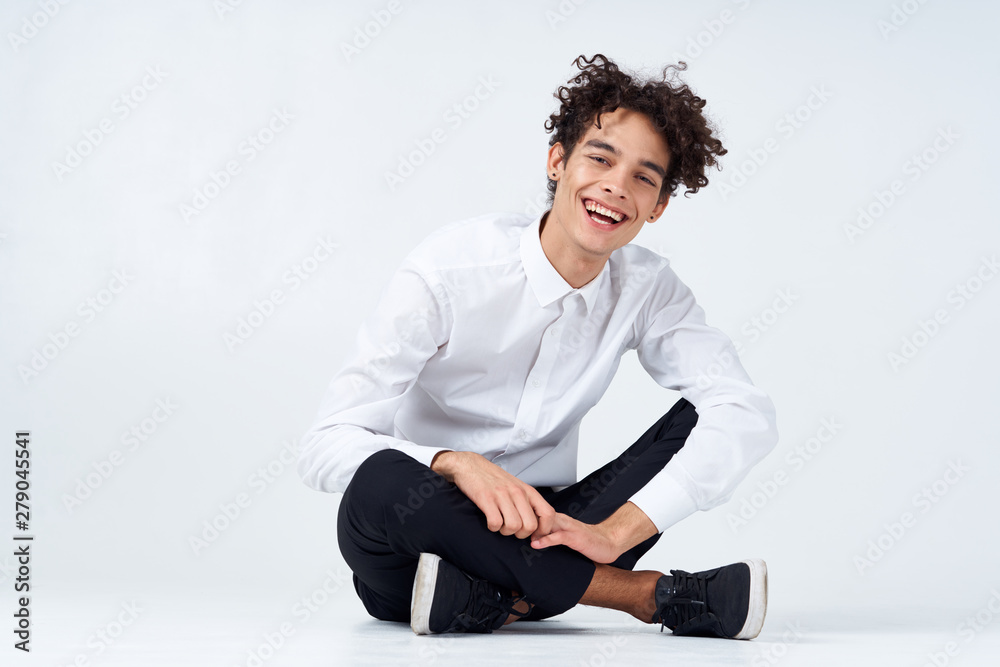 portrait of young man sitting on the floor portrait of young man sitting on the floor