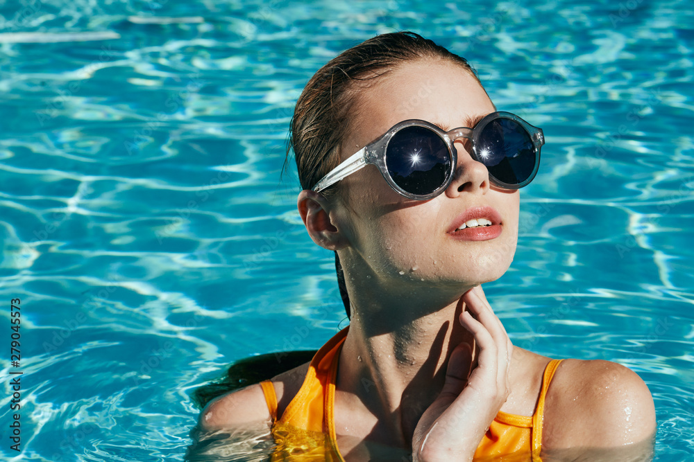young woman in black goggles in swimming pool