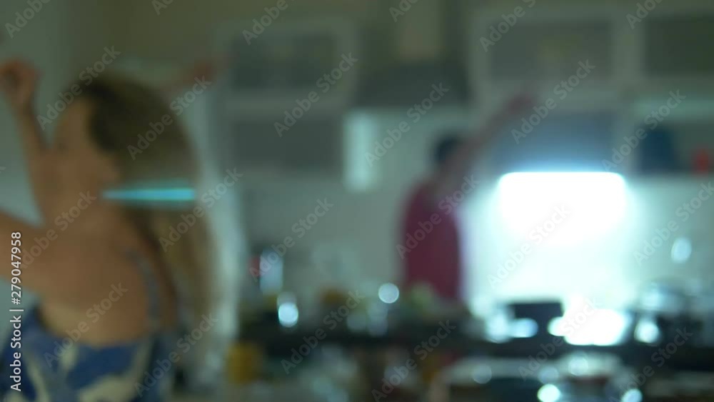 blurred background. home party concept. people dancing in the kitchen near the bar in the house. blurred background. home party concept. people dancing in the kitchen near the bar in the house.