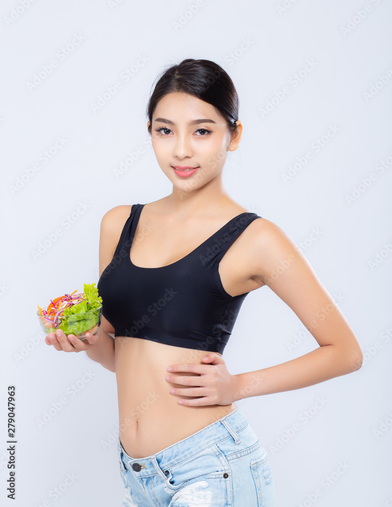 Beautiful portrait young asian woman smiling holding salad vegetable food isolated on white background, girl diet eating vegetarian for healthy, health care or wellness concept. Beautiful portrait young asian woman smiling holding salad vegetable food isolated on white background, girl diet eating vegetarian for healthy, health care or wellness concept.