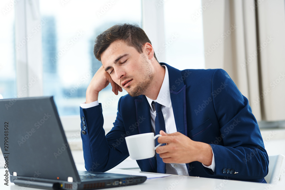 businessman sitting at desk in office businessman sitting at desk in office