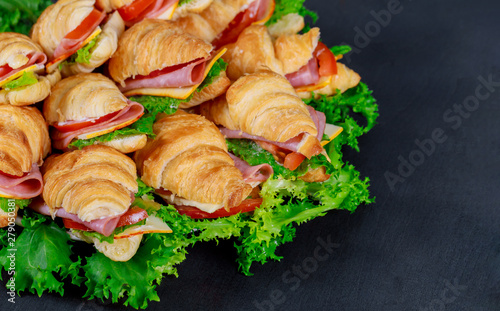 Croissants with ham, cheese and tomato on plate